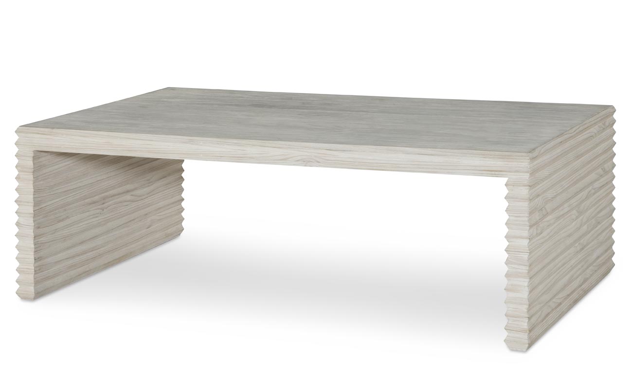 The Belmont Coffee Table in White Rustic Pine sits in a studio.