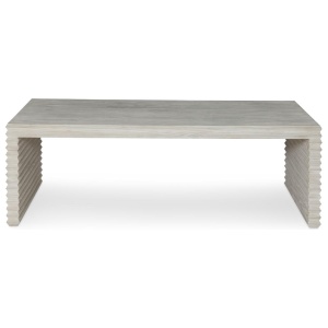 The Belmont Coffee Table in White Rustic Pine sits in a studio.