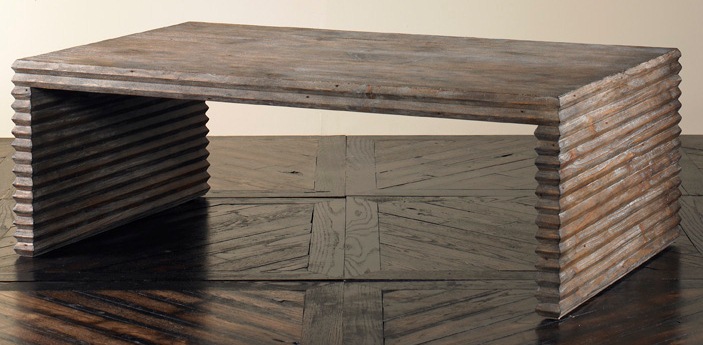The Belmont Coffee Table in Rustic Grey Pine sits in a studio.