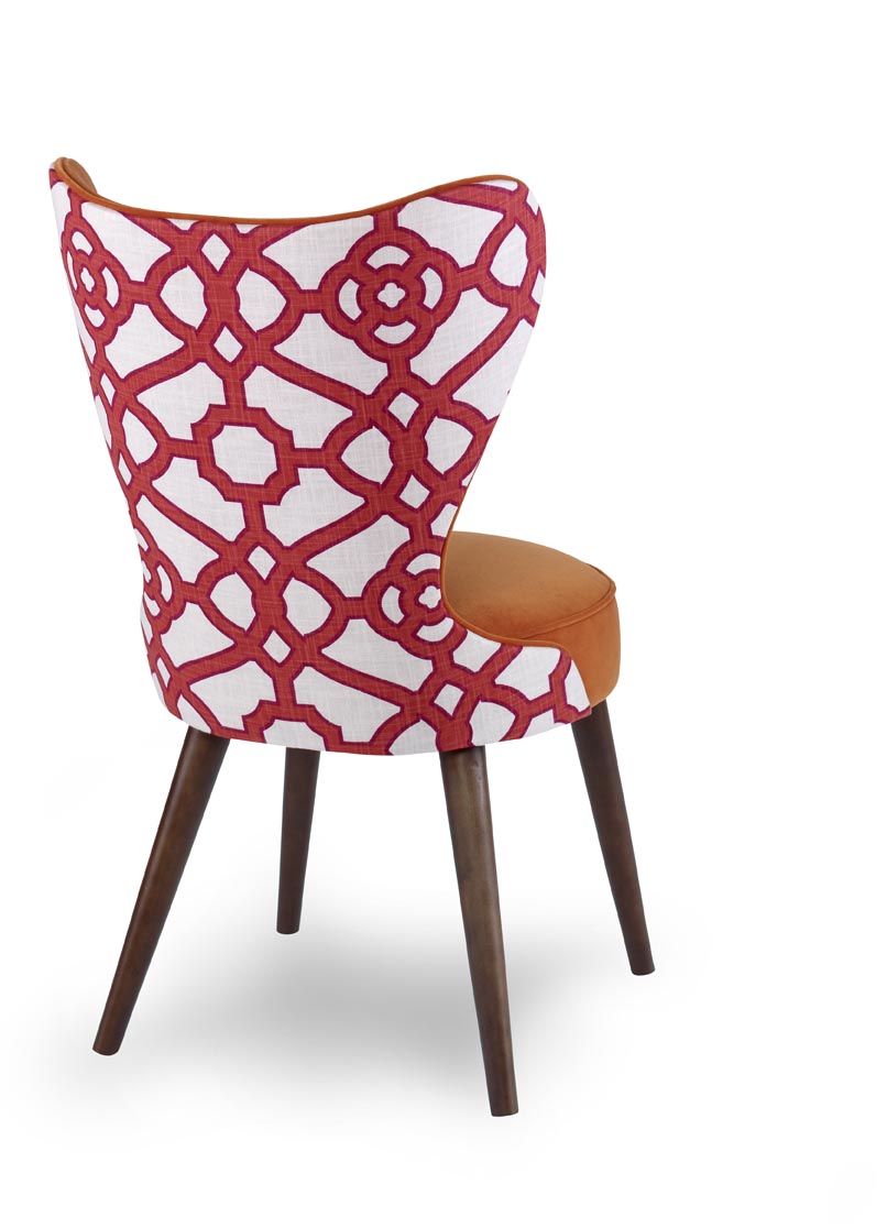 The Maribella Chair in Marmalade Velvet with Custom COM back sits in a studio.