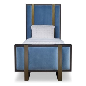 The Mercer Bed, Twin in Warm Dark Oak and Harbour Velvet sits in a studio.