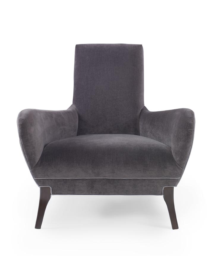 The Naomi Chair in Dark Grey Velvet with Dark Maple Finishes sits in a studio.