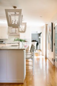A luxury kitchen with grey, white, and organic colors.