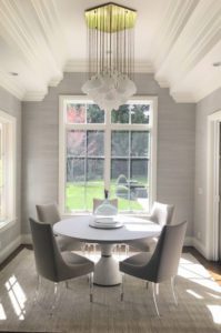 A comfortable, light organic modern dining room with a great view.